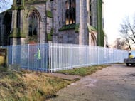 Palisade being fitted to protect the church during repairs